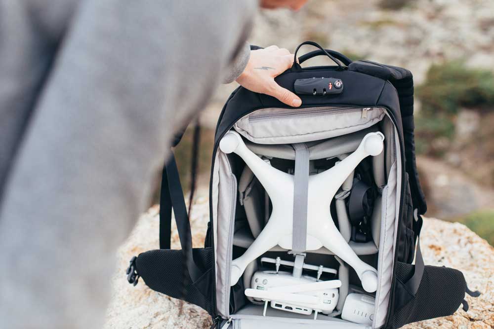 Professional multimedia backpack with storage compartments and straps to secure equipment, including a drone.